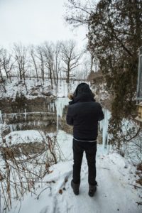 adrian-in-black-jacket-in-front-of-frozen-tew-falls-hamilton-ontario-2018