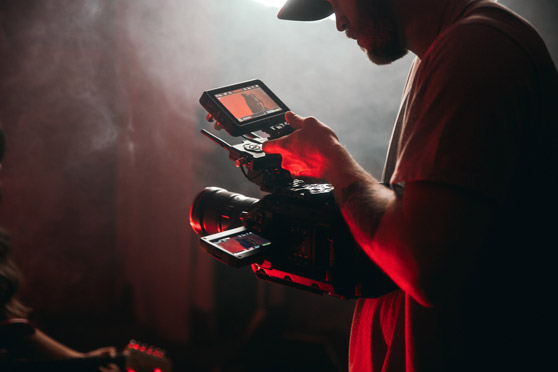 male-cinematographer-filming-with-a-vintage-lens