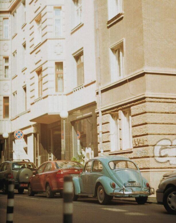 vintage film aesthetic photographs of a street with old cars in-between buildings