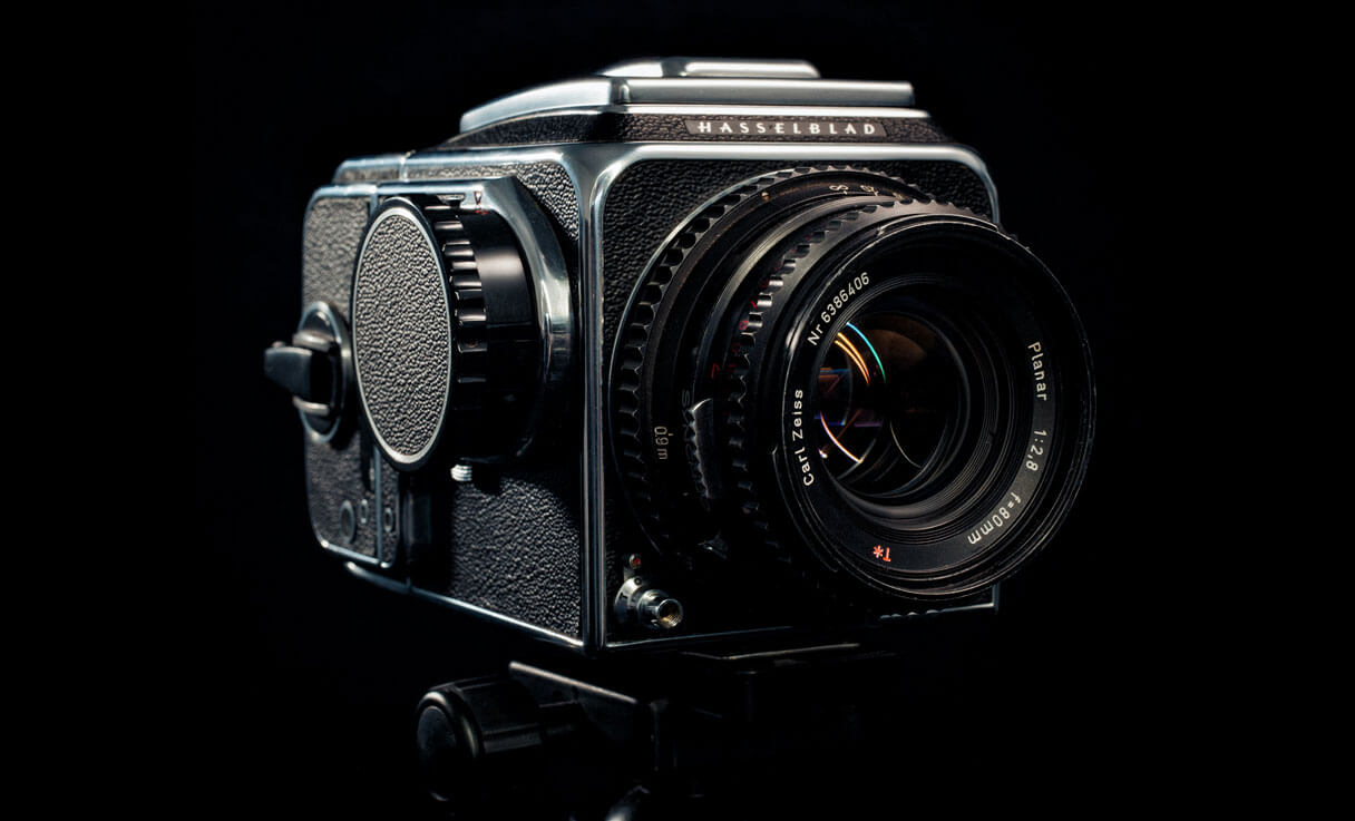 vintage-hasselblad-medium-format-film-camera-on-tripod-black-background