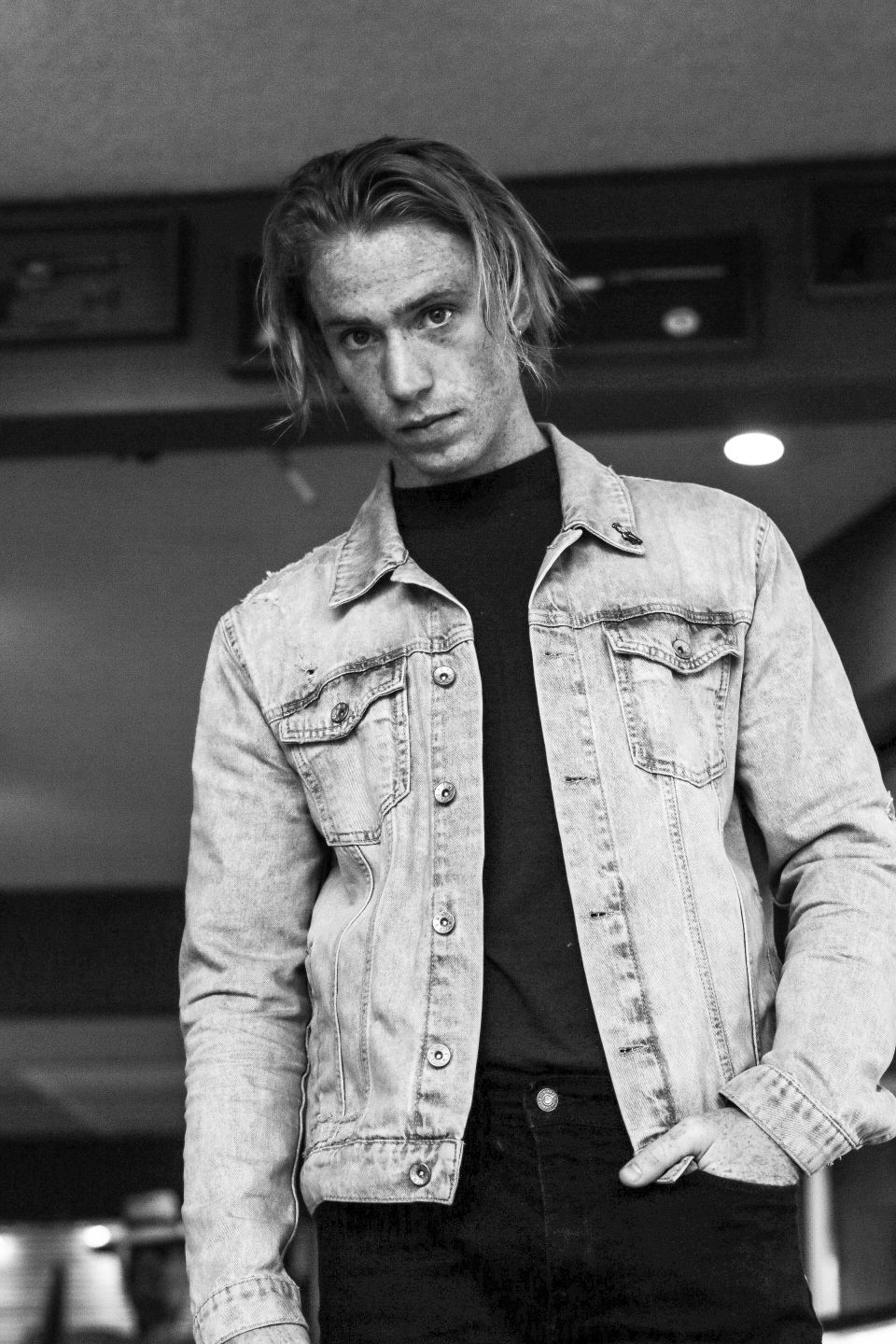 vintage black and white fashion portrait of a man in jean jacket